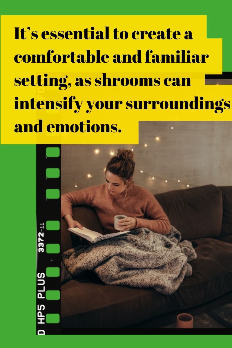 a women with a cup of tea sitting on the couch with blankets and a book